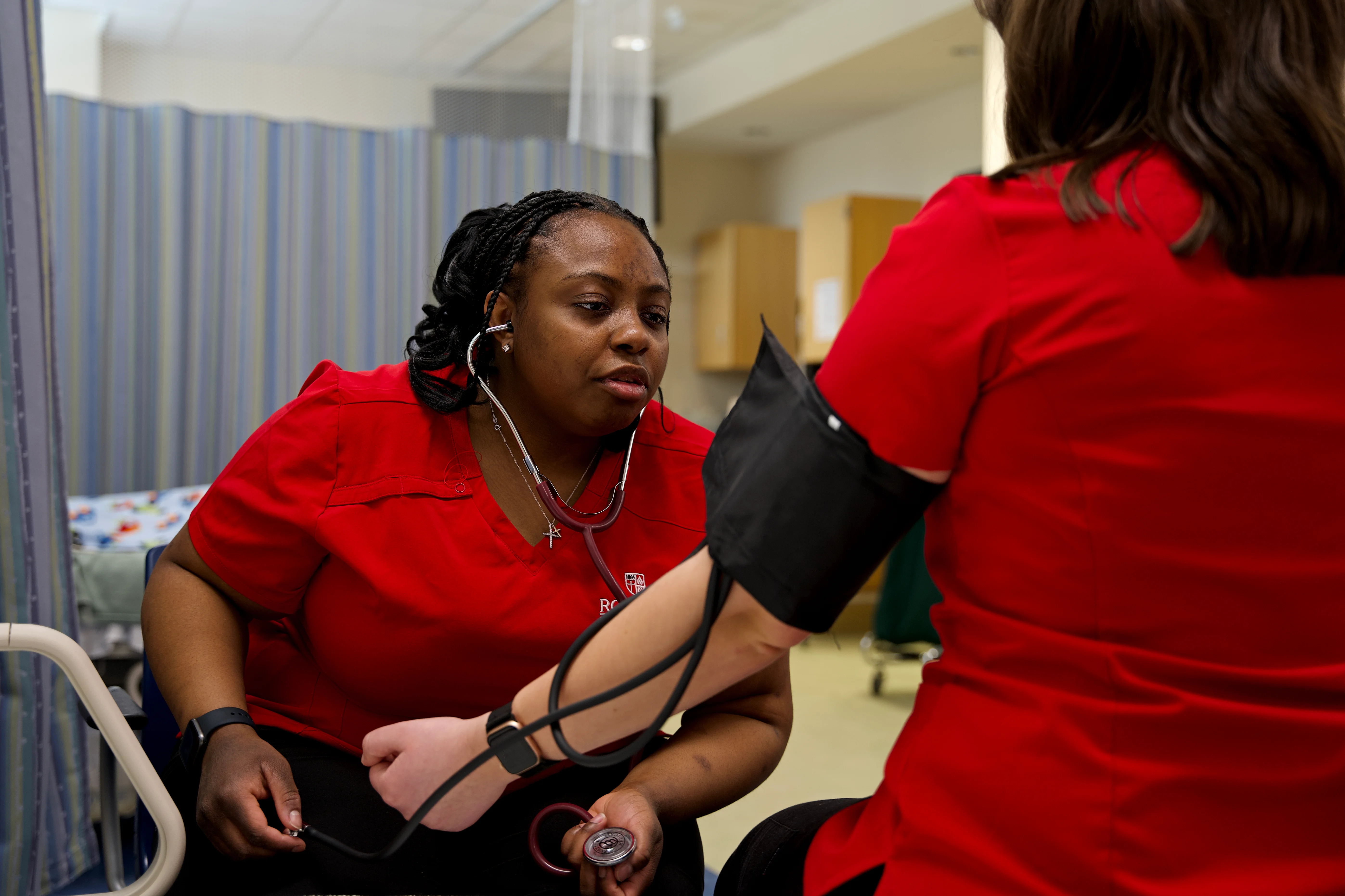 Nursing students taking blood pressure