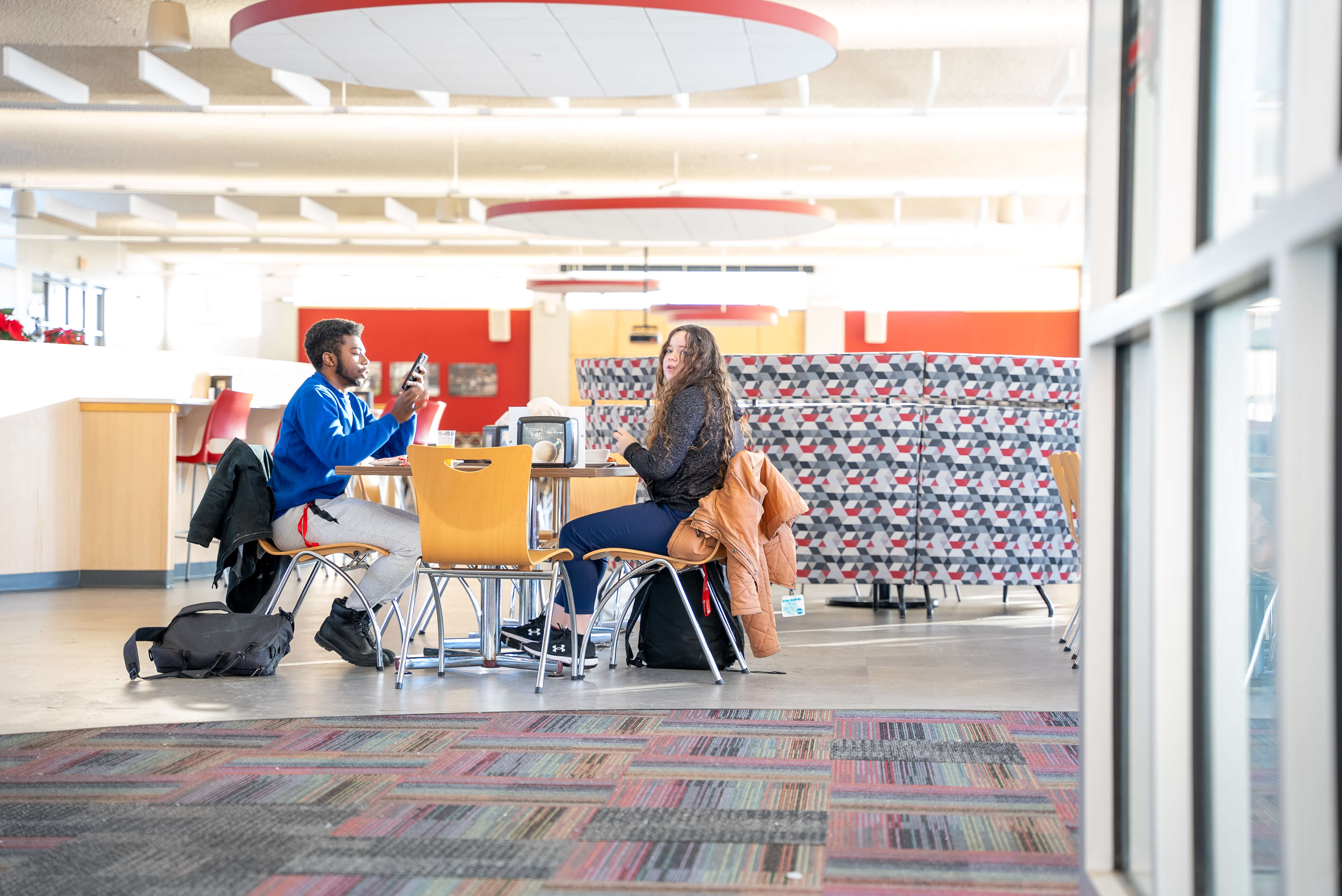 Two students eating lunch in Garlock Dining Commons at Roberts