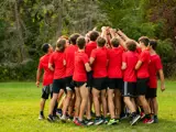 A sports team huddles