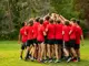 A sports team huddles